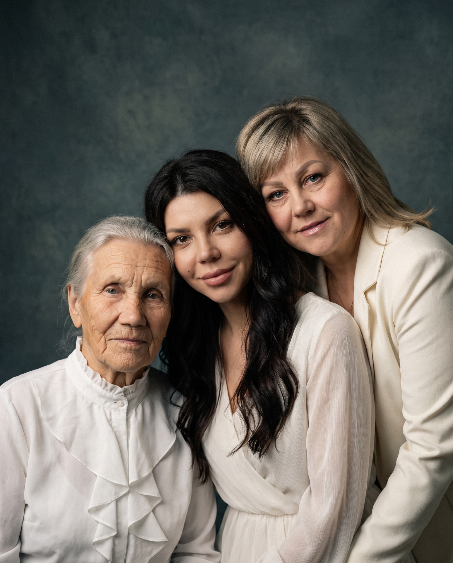 Fine art portrait of a grandmother, mother and daughter together in ivory clothing
