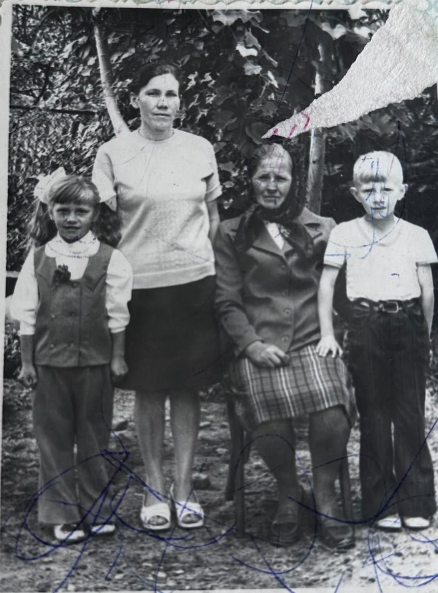 Original damaged family photograph with ballpoint pen marks across the faces